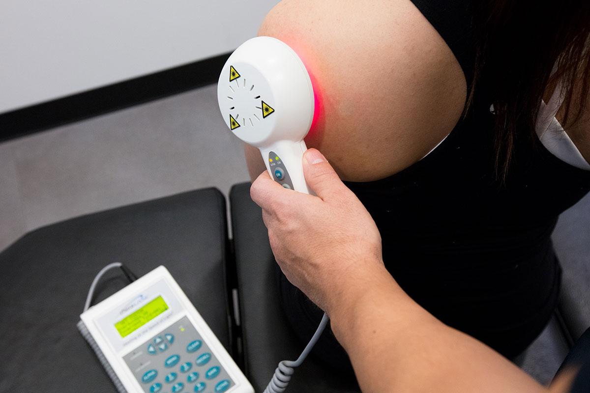 nCold-Laser-therapy-FBL.2-164 A chiropractor performing a spinal adjustment on a patient in Vancouver, focusing on upper back and shoulder alignment