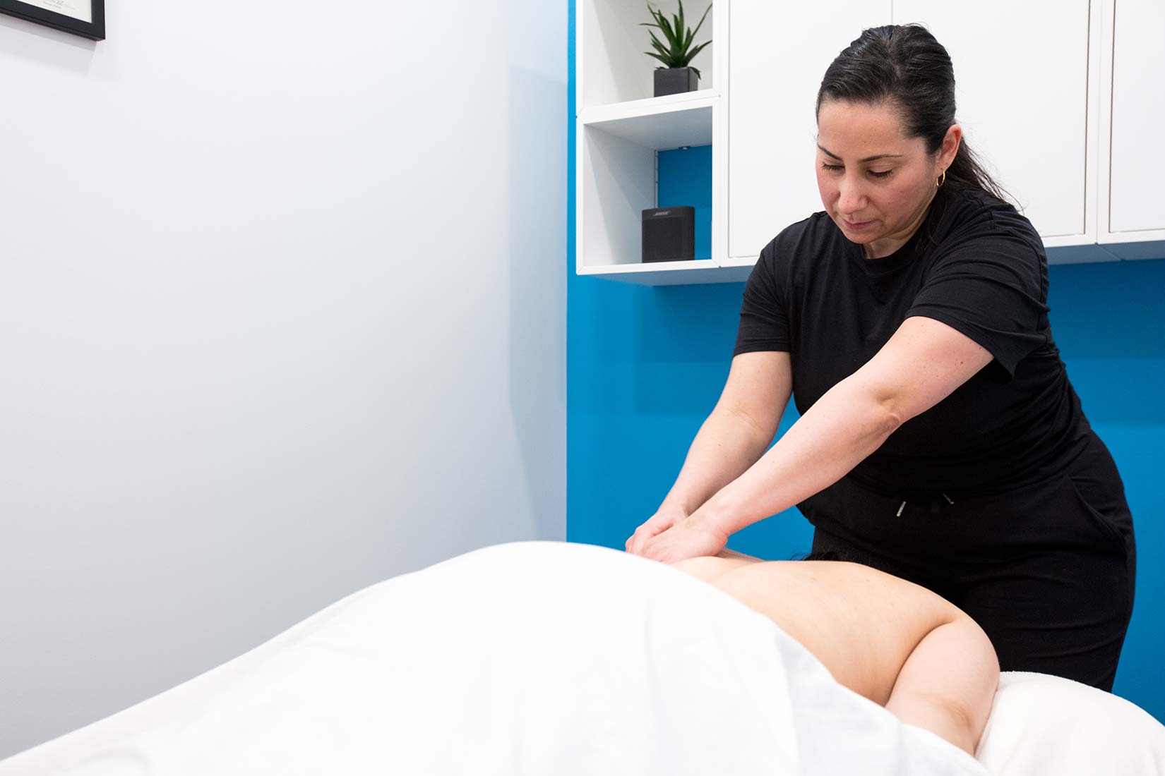 Registered massage therapist providing back treatment in a professional Vancouver RMT clinic